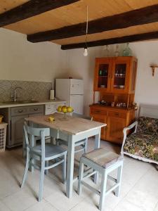 a kitchen with a table and two chairs and a kitchen with a table at Casa Luna Betiluna in Ciclova-Montană +31 photos
