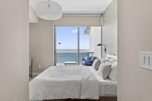 a bedroom with a bed with a view of the ocean at Ocean 2 Sky at Monte Carlo Miami Beach in Miami Beach