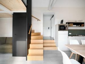 a staircase in a room with a table and a kitchen at Aparthouse HAAS41 - Eupen in Eupen