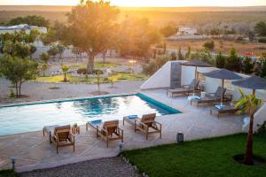 an image of a swimming pool with chairs and umbrellas at Villa de luxe Sakina in Essaouira +52 photos