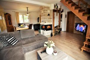 a living room with a couch and a fireplace at Villa Suzana's Nature Hideout in Gospić