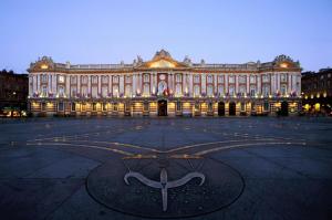 a large building with a sign in front of it at Le Brienne Toulouse Centre in Toulouse