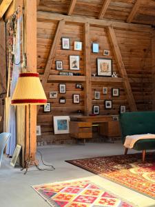 a living room with a wooden wall with pictures at Siedlisko Dobrych Snów in Stare Juchy