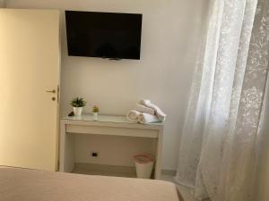 a bedroom with a bed and a television on a wall at Il Rifugio in Sulmona