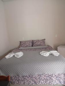 a bedroom with a bed with towels on it at Hotel AD Cassilândia in Cassilândia