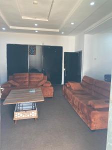 a living room with a couch and a coffee table at CZ Apartments in Bardon Yana