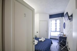 a bedroom with a blue bed and a window at Albergo Al Carugio in Monterosso al Mare