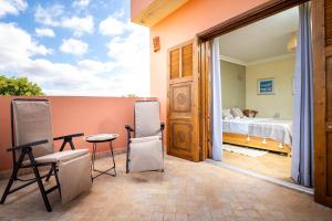 a room with a bed and a table and chairs at Villa de luxe Sakina in Essaouira