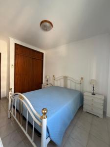 a bedroom with a bed and a wooden door at Rabelo C in Armação de Pêra +7 photos