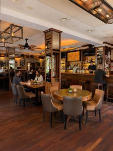 a restaurant with tables and chairs and a bar at Hotel-Restaurant Amadeus in Hannover +41 photos