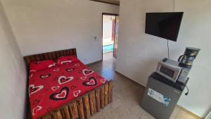 a bedroom with a bed and a television in it at Cabañas de Asgard in Nueva Gorgona