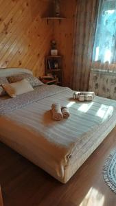 a large bed with two towels on top of it at Vila Krismark in Žabljak