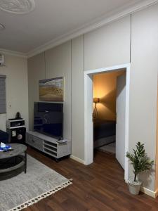 a living room with a flat screen tv and a couch at شقق الفيصل in Al Khobar