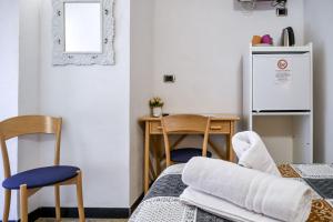 a room with a table and chairs and a refrigerator at Albergo Al Carugio in Monterosso al Mare