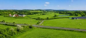 an aerial view of green fields and a road at Maison Lanty in Lanty