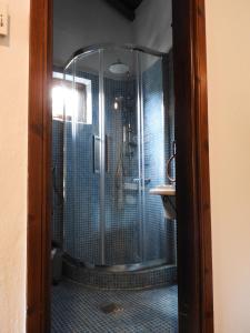a glass shower in a bathroom with a sink at Olivia traditional stone house in Nikiti +10 photos