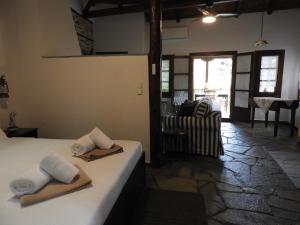 a room with a bed with towels on it at Olivia traditional stone house in Nikiti