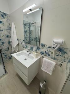 a bathroom with a sink and a mirror at B&B La Perla di Praia in Praia a Mare