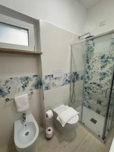 a bathroom with a shower and a toilet and a sink at B&B La Perla di Praia in Praia a Mare