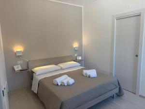 a bedroom with a bed with towels on it at B&B La Perla di Praia in Praia a Mare +20 photos