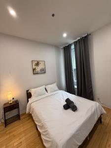 a bedroom with a white bed and a window at Downtown Studio for 2 with Free private parking in Montreal +6 photos