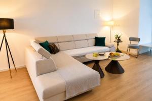 a living room with a couch and two tables at Casa Mia in Višići