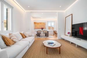 a white living room with a white couch and a table at Casa Lux Forte dei Marmi in Forte dei Marmi