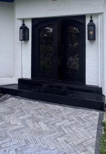 a black door on the side of a house at Steps from beach with open fire pit in Gulfport