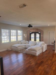 a living room with white couches and a fireplace at Steps from beach with open fire pit in Gulfport +10 photos