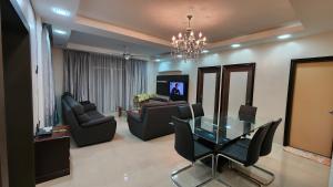 a living room with a glass table and chairs at Centrum Homstay at Crown Imperial Court in Cameron Highlands