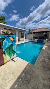 a painting of a swimming pool next to a house at Cabañas de Asgard in Nueva Gorgona
