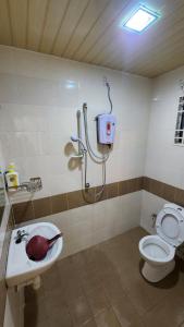 a bathroom with a toilet and a sink and a shower at Centrum Homstay at Crown Imperial Court in Cameron Highlands +78 photos