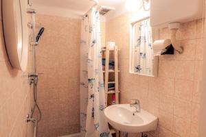 a small bathroom with a sink and a shower at Mediterranean Family design in Izola +14 photos