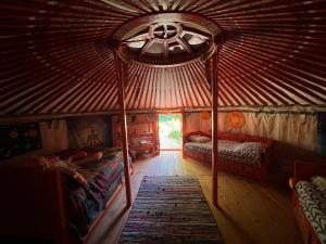 a room with two beds in a yurt at Yourte piscine jacuzzi in Gréoux-les-Bains