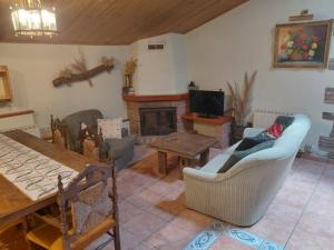 a living room with a table and a fireplace at Nova Forest Montseny in Montseny