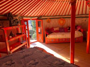 a bedroom with a bed in a gazebo at Yourte piscine jacuzzi in Gréoux-les-Bains +13 photos