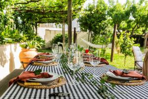a table with plates of food and glasses on it at Just Like Home - Casa Antonio em Paredes de Coura in Paredes de Coura