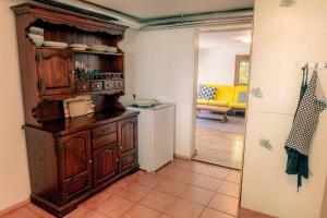 a kitchen with a wooden cabinet in a room at Mediterranean Family design in Izola