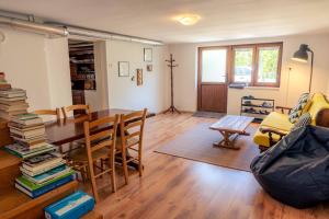 a living room with a dining room table with books at Mediterranean Family design in Izola