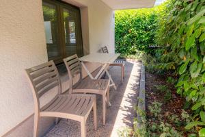 a wooden table and chairs on a patio at Mediterranean Family design in Izola