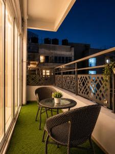 a patio with two chairs and a table on a balcony at Elvora Stay's - Studio with Jacuzzi in Ghaziabad
