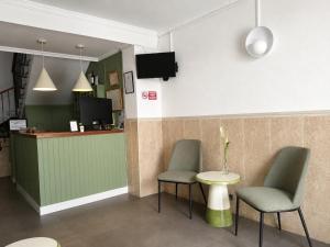 a waiting area with two chairs and a table at Hostal Paco Marbella in Marbella +16 photos
