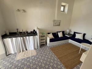 a living room with a couch and a sink at Il Portico sul mare in Santa Marina Salina +16 photos
