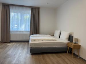 a bedroom with a bed and a large window at Blue Stay Bremen in Bremen