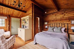 a bedroom with a bed in a wooden room at Madeira House in Jenner