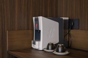 a coffee machine sitting on top of a table at Quartz Hotel Vlore in Vlorë
