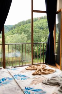 a bed in a room with a view of a mountain at Villa Loni in Pozharan +4 photos