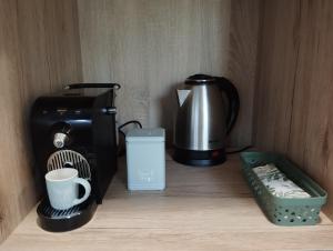 a coffee maker and a toaster sitting on a counter at Apartma Pod Hrastom in Koper
