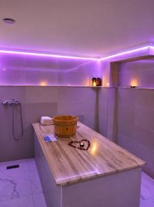 a bathroom with a wooden counter with purple lights at Unico Hotel & Spa Casablanca in Casablanca +65 photos