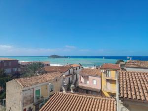 a view of the ocean from the roofs of a town at B&B il Palazzo Cirella in Cirella
